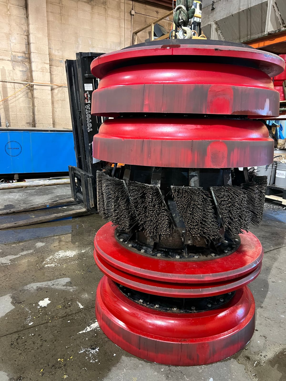 The same brush pig after washing, red cups and clean wire brushes visible